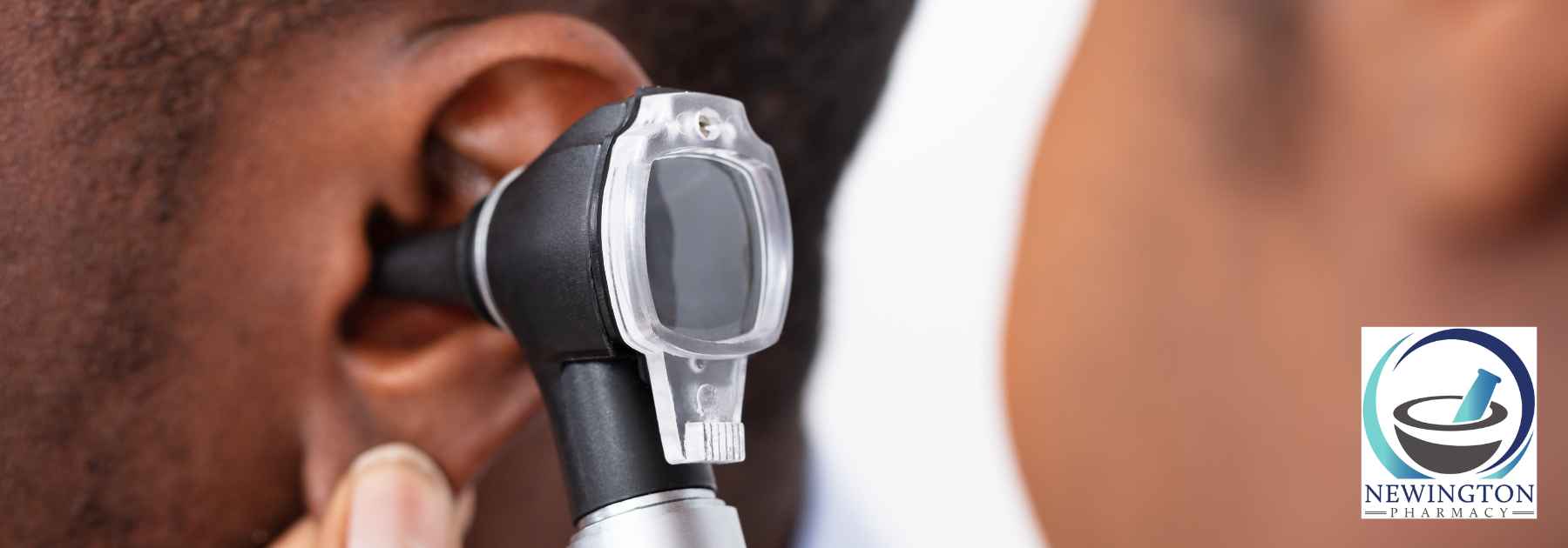 close-up of doctor examining ear of patient