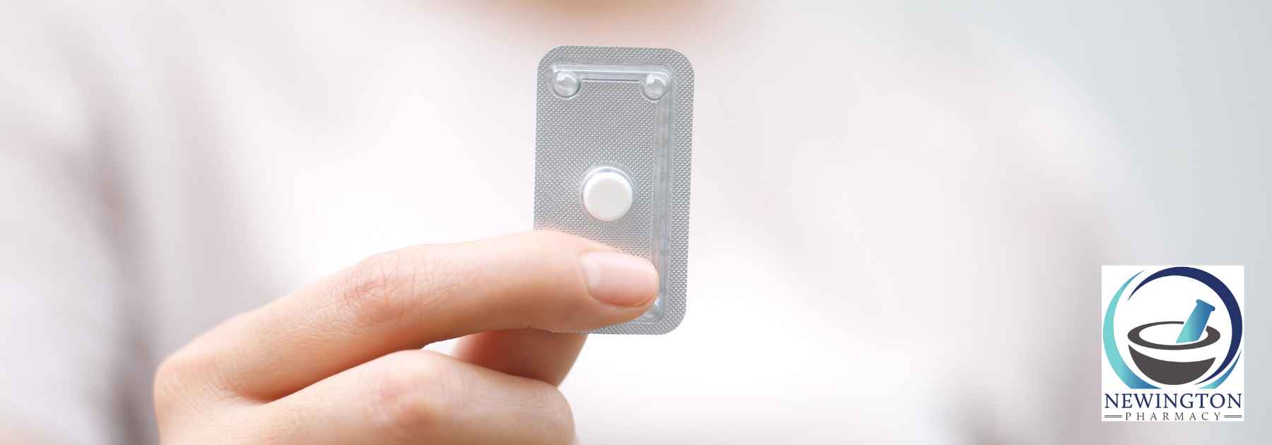 close-up of person holding emergency contraceptive pill