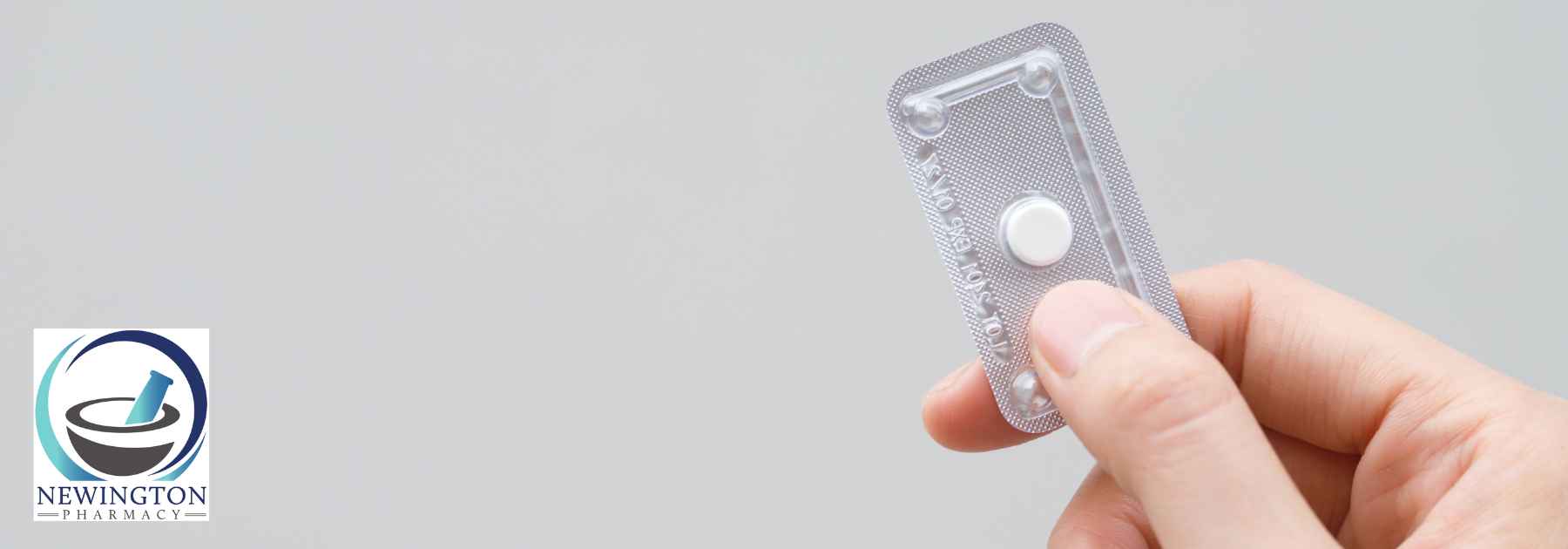 person holding emergency contraceptive pill on grey background