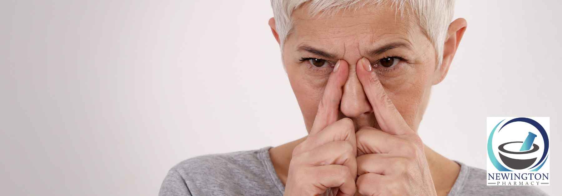 older woman pressing her nose
