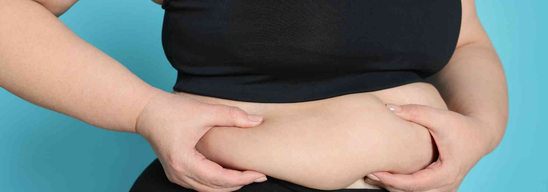 overweight woman clutching her stomach