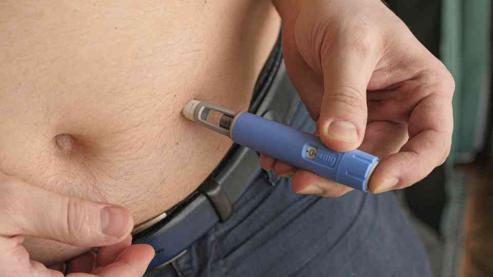 person injecting weight loss injection