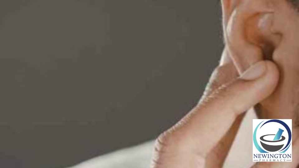 man clutching ear in discomfort