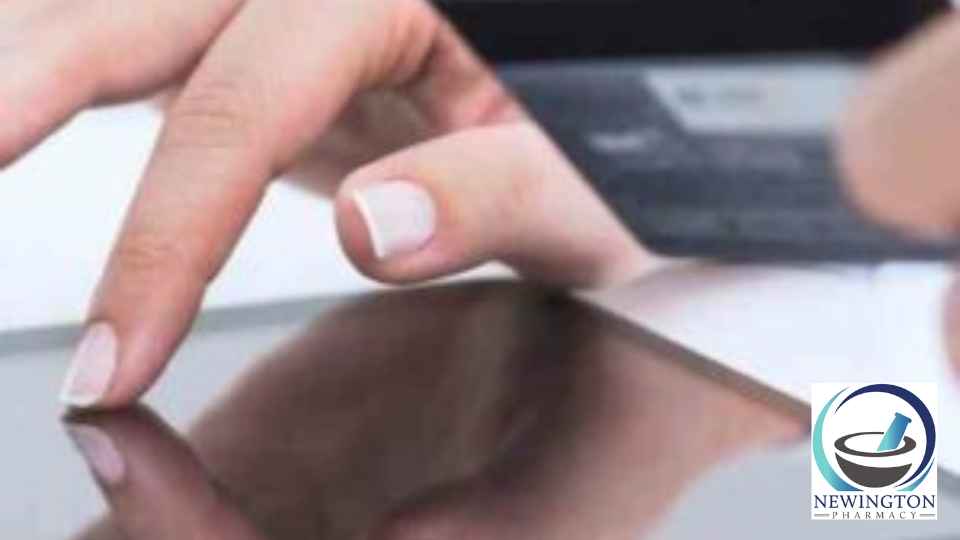 person scrolling on tablet holding credit card