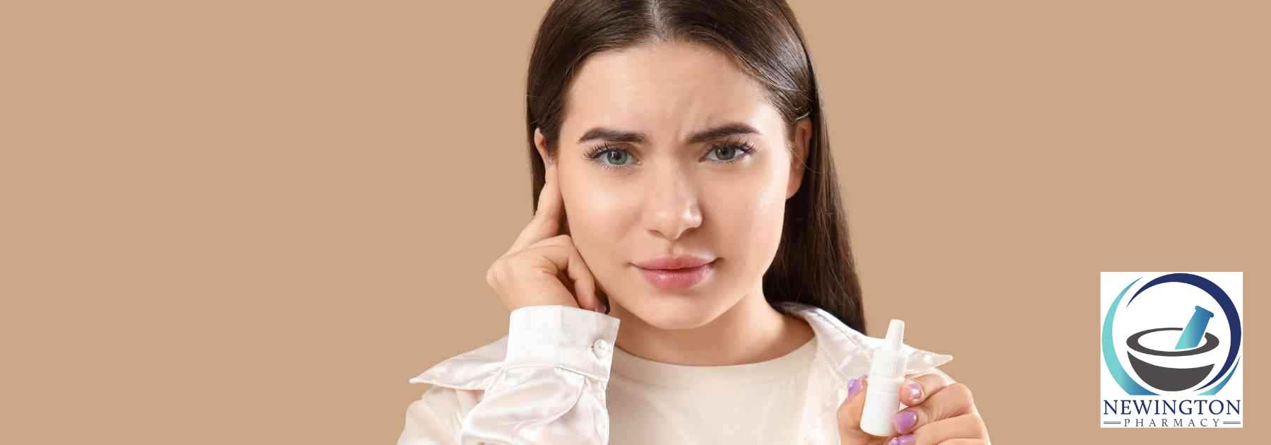 girl holding bottle of ear drops