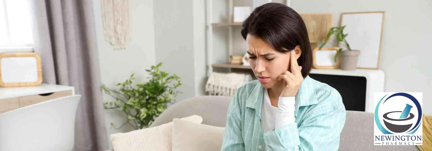 woman pressing her finger on her ear in discomfort