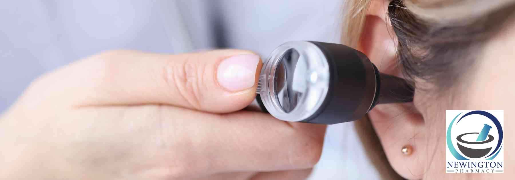 doctor inspecting ear of female patient