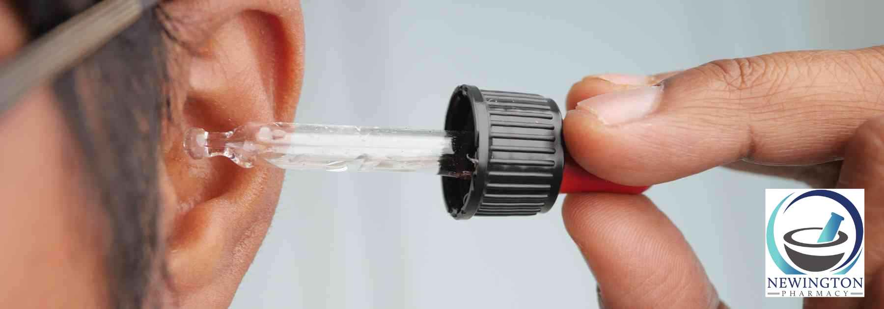 man putting ear drops in ear