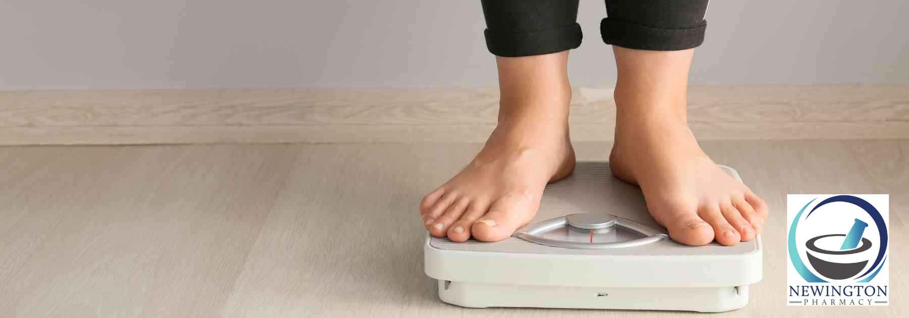 person in black trousers standing on scales
