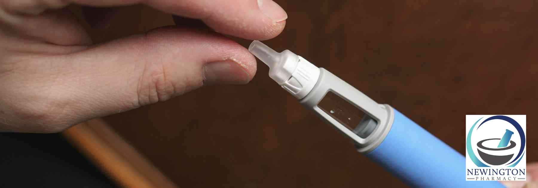 person holding blue weight loss injection