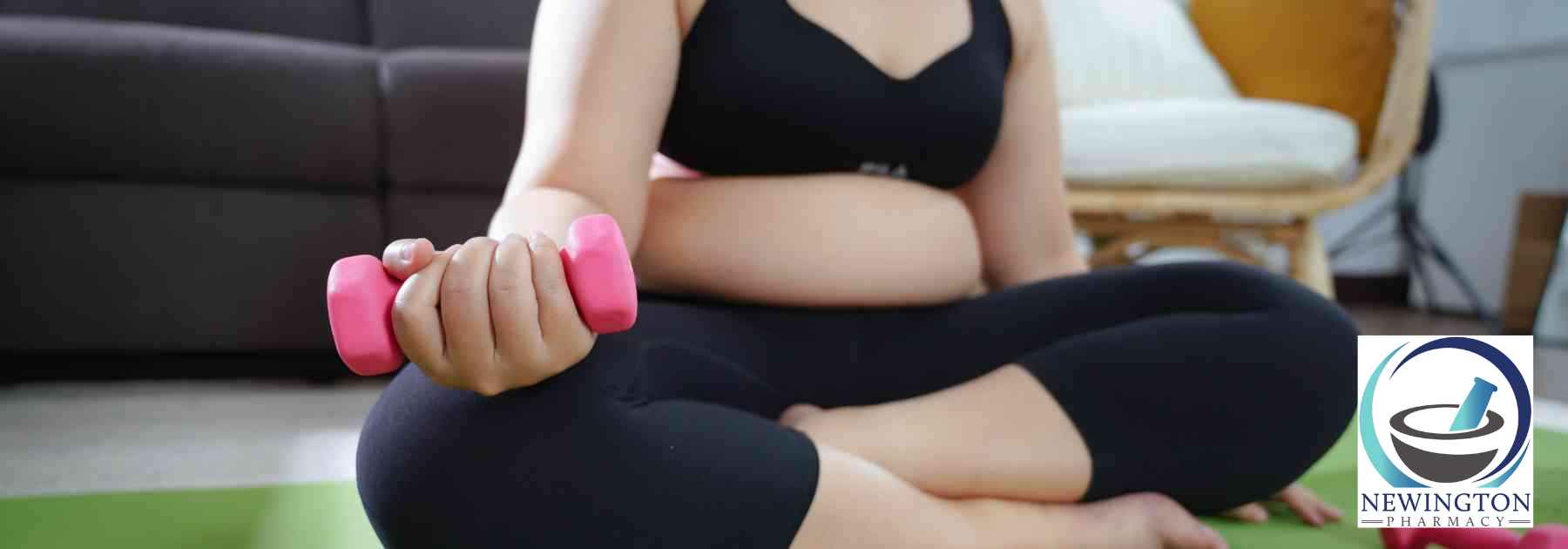 overweight woman in workout gear lifting weight