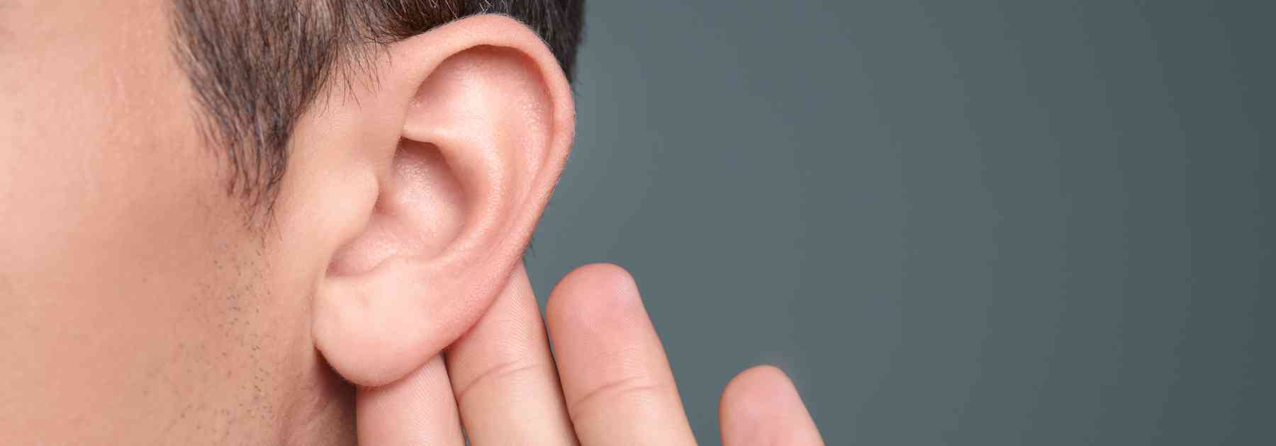 close-up of person holding their ear