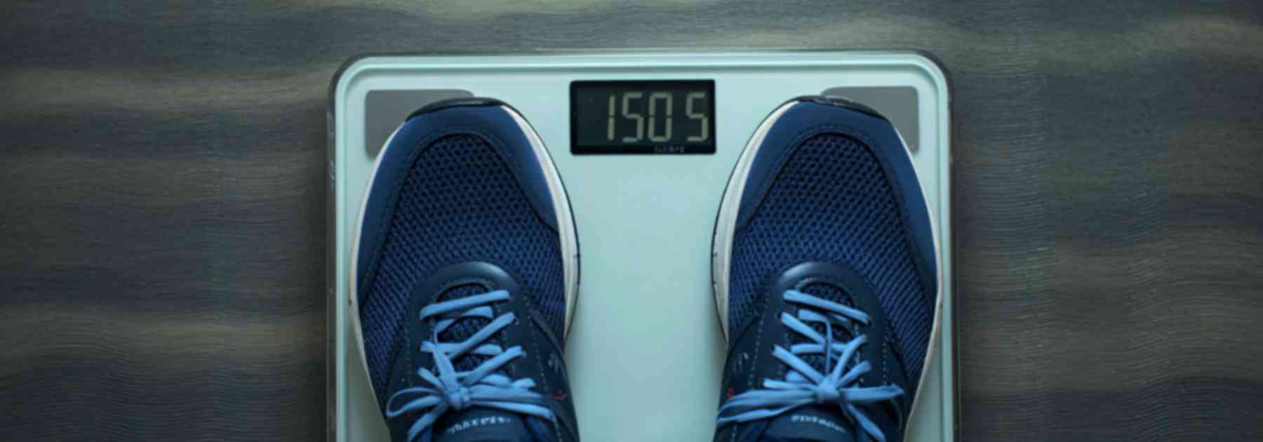 person in blue shoes standing on scales