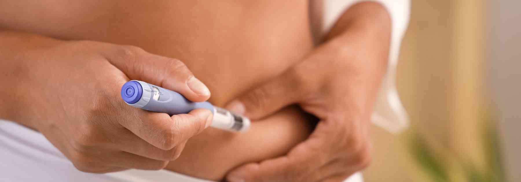 close-up of person using weight loss injection
