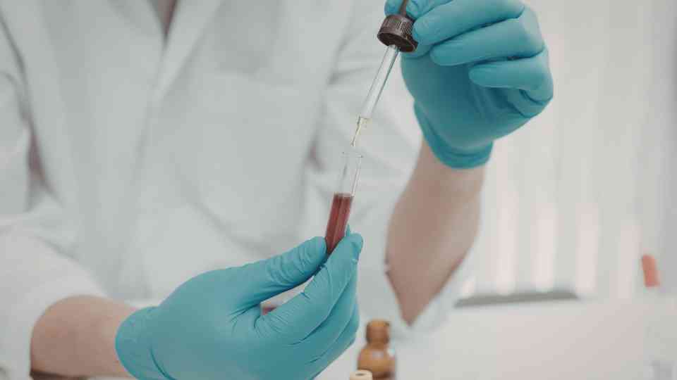 person in laboratory examining blood test