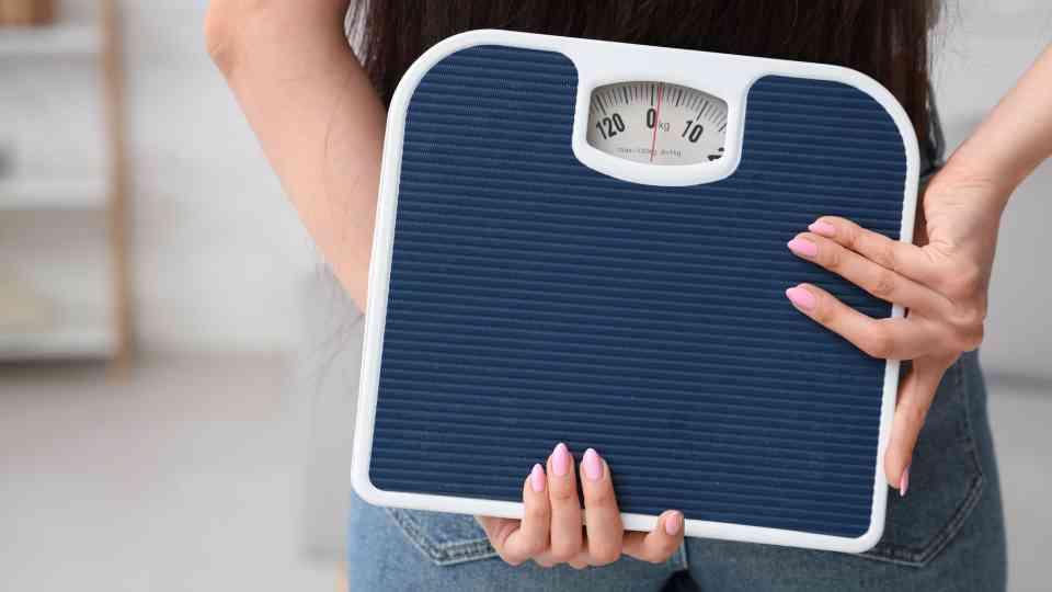 woman holding blue set of scales