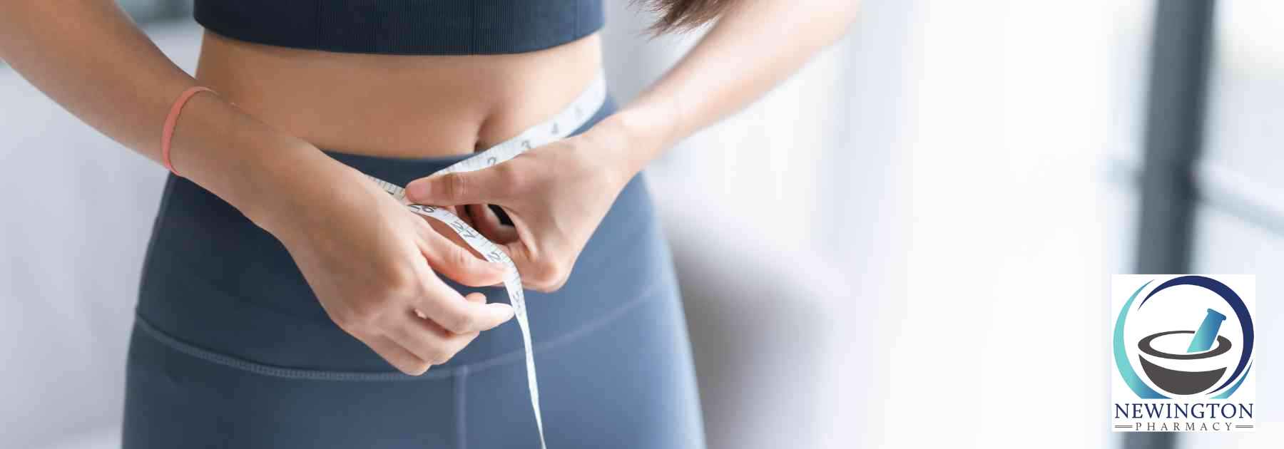 woman in workout gear measuring waist