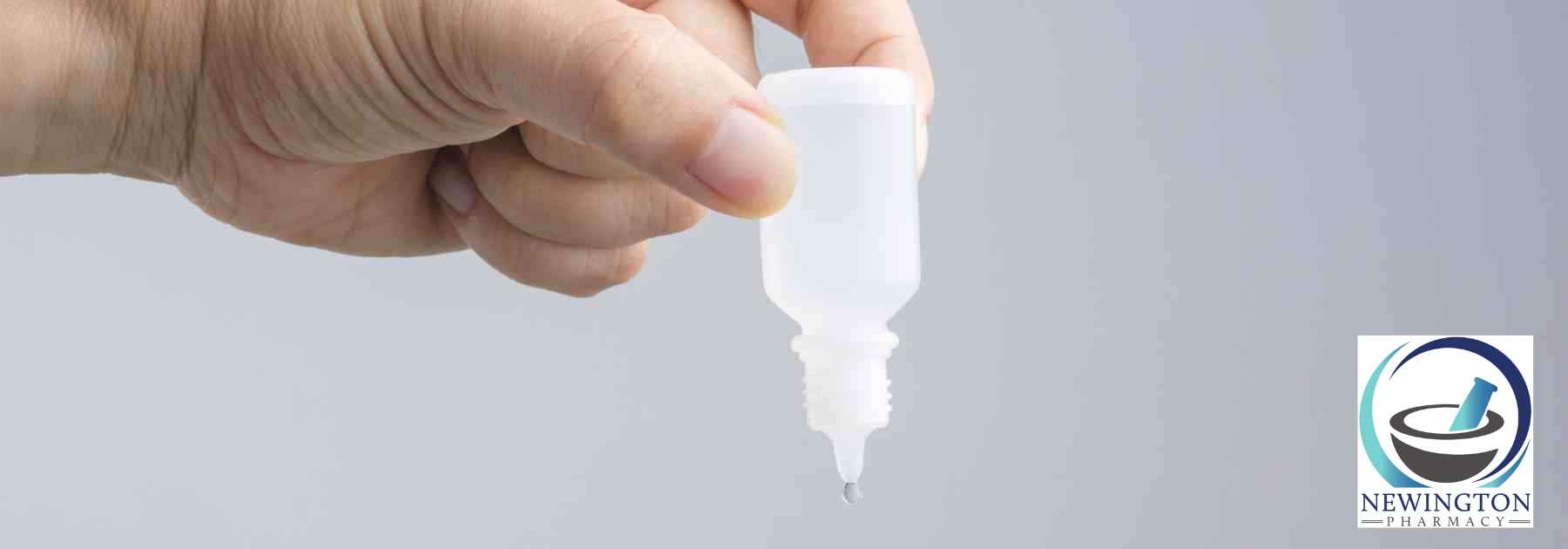 person holding bottle of ear drops upside down