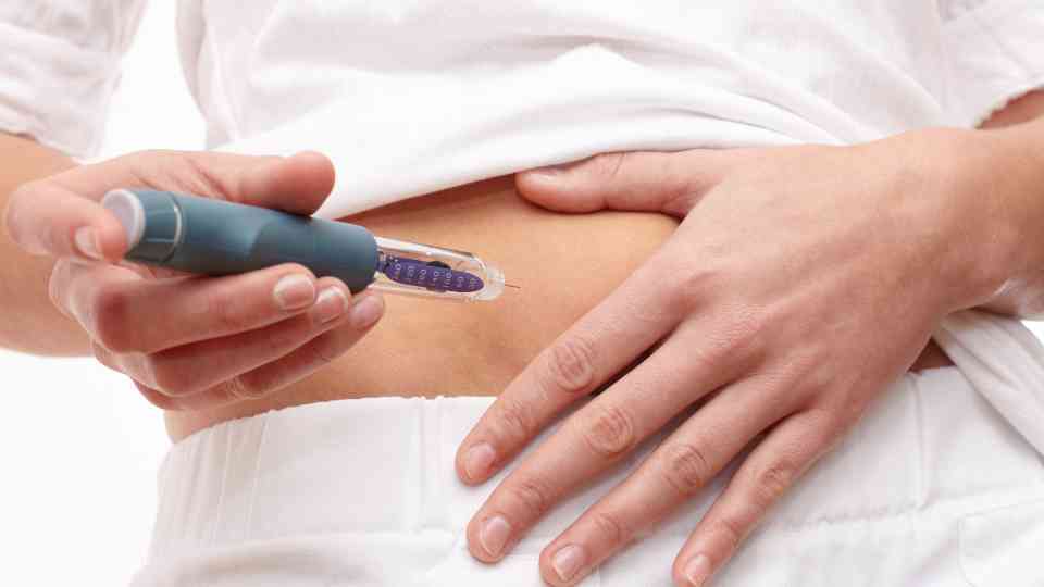 person in white clothes using weight loss injection