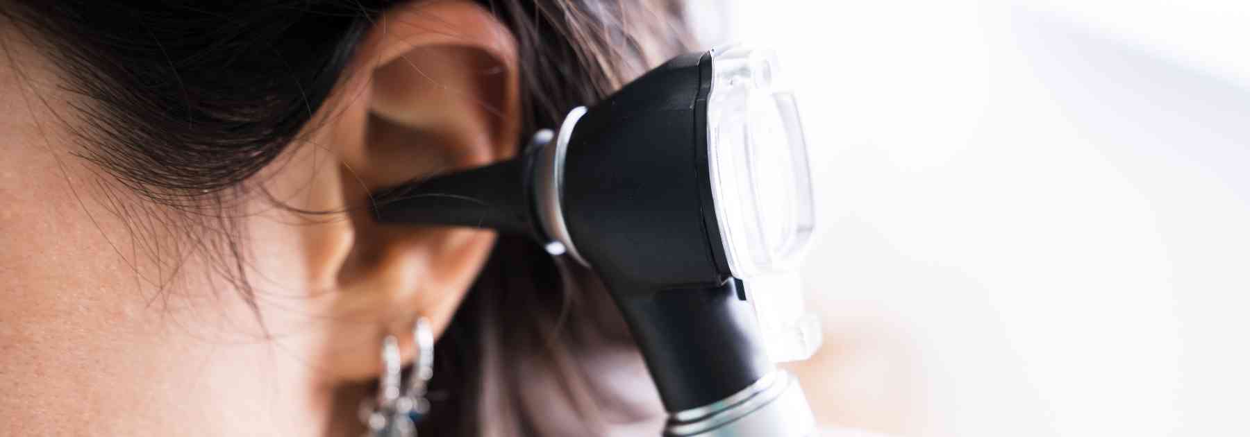 female patient having her ear examined