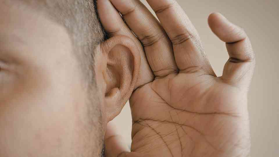 young man holding his ear