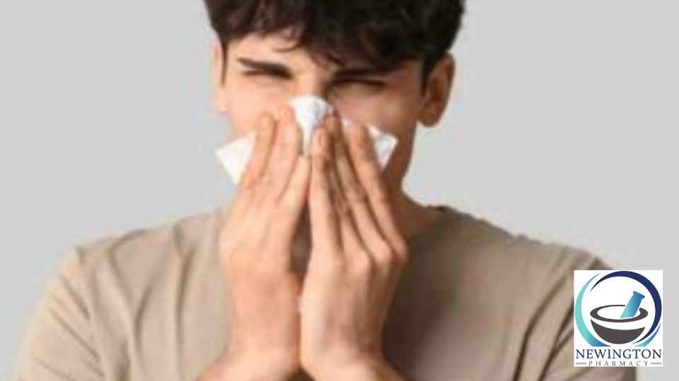 young man blowing his nose