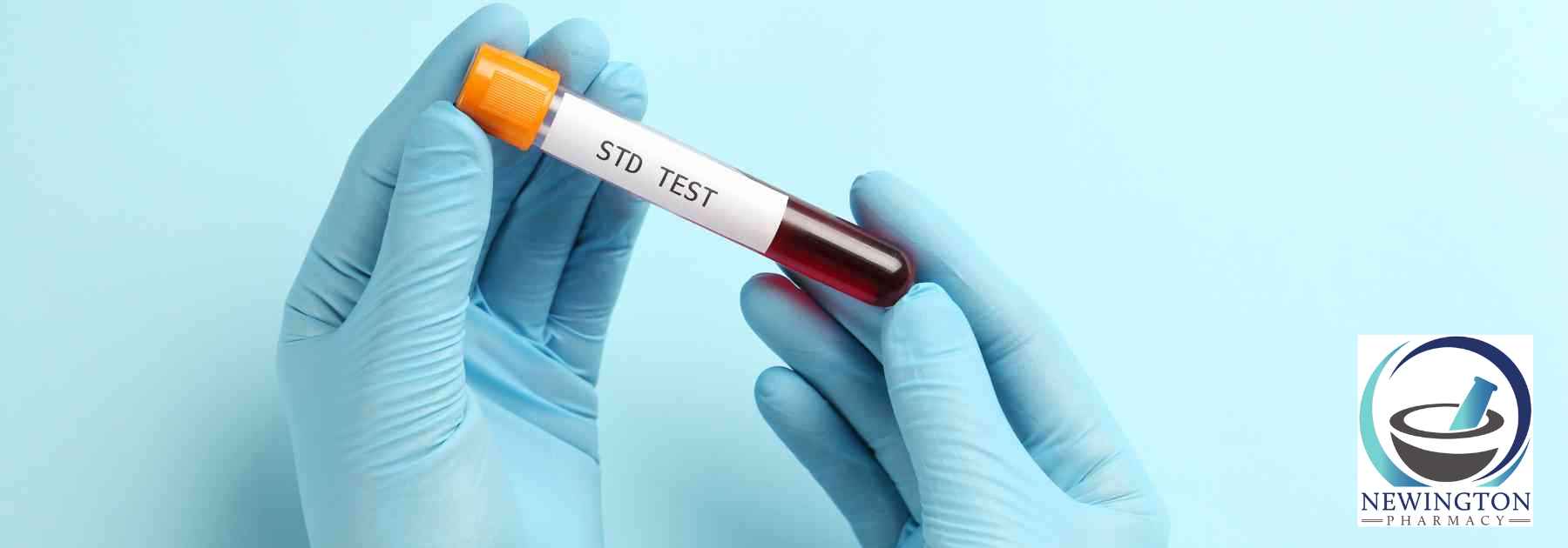 person wearing medical gloves holding std blood test on blue background