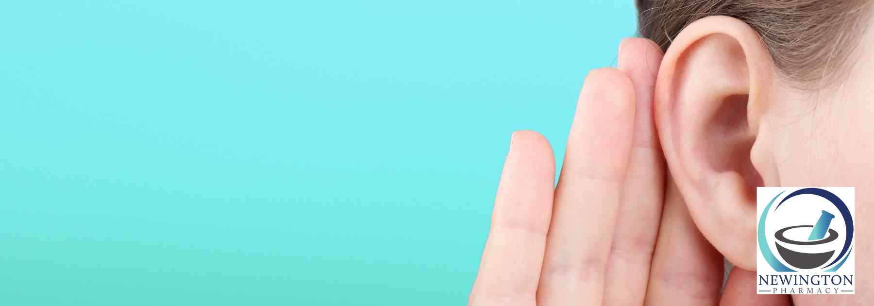 person holding their ear on turquoise background
