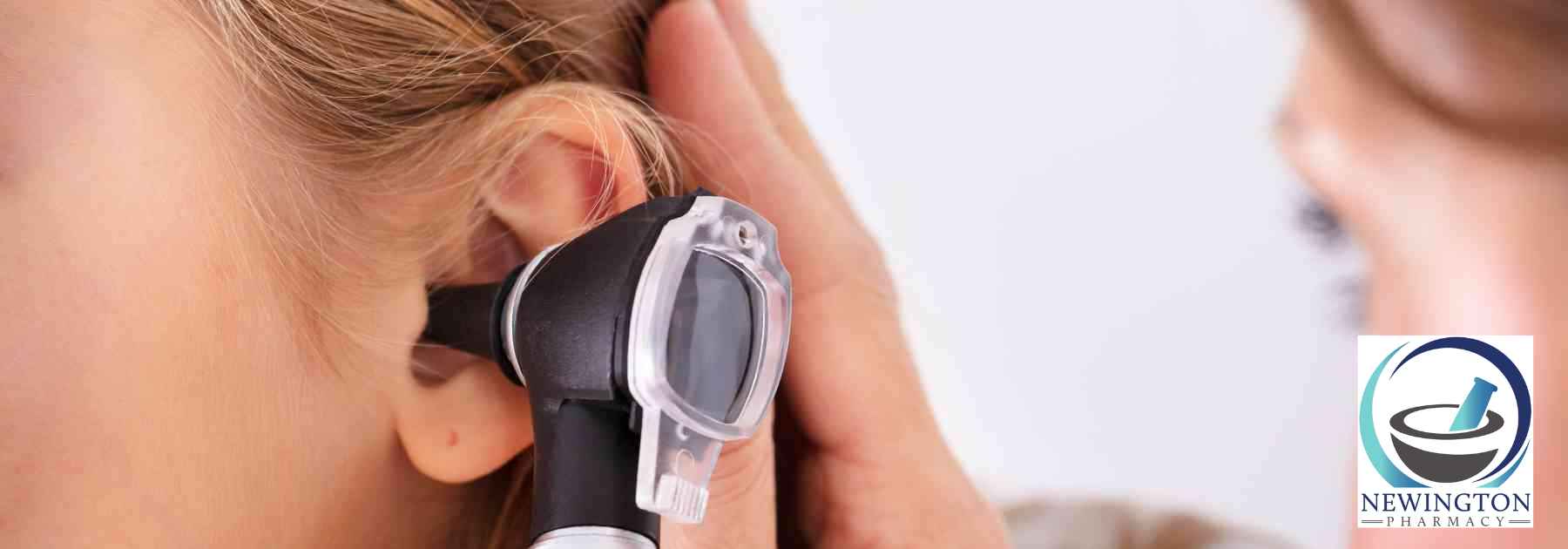 doctor examining ear of female patient