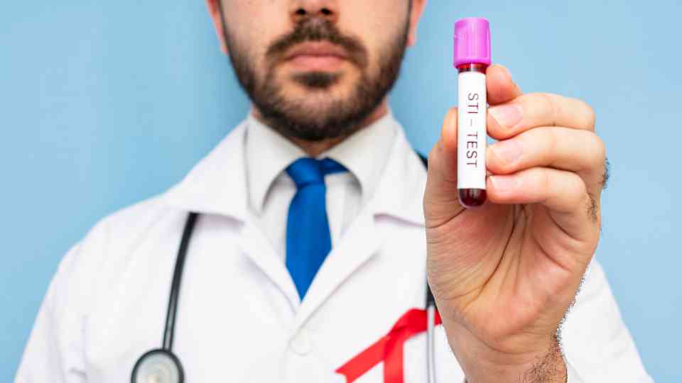 male doctor holding sti blood test