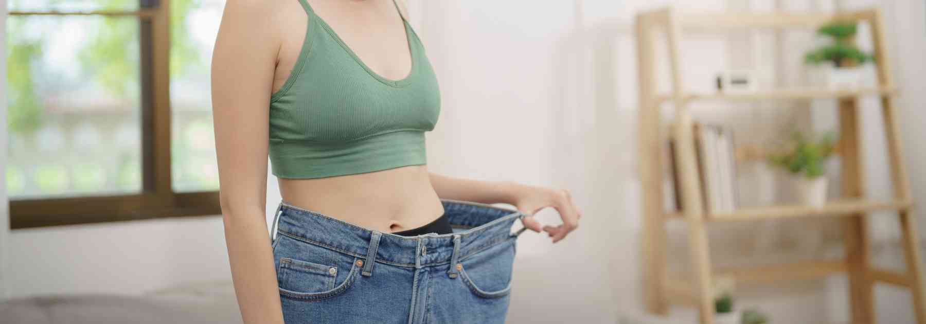 woman in green crop top wearing jeans too big