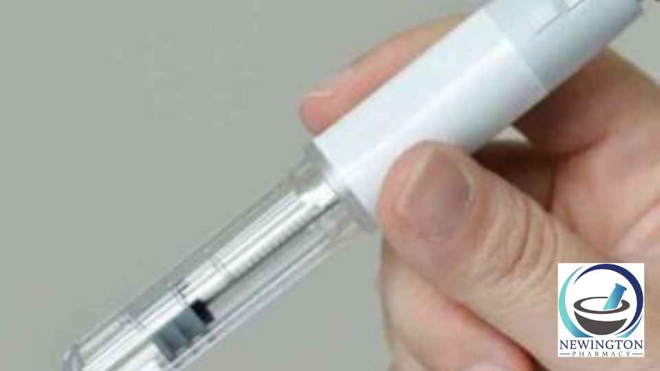 person holding weight loss injection on grey background