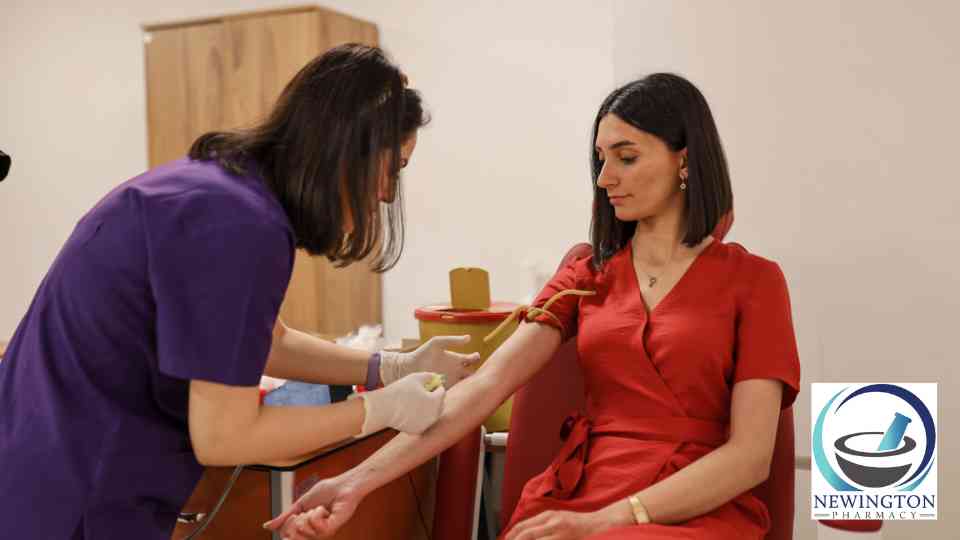 female patient in red dress at blood test appointment