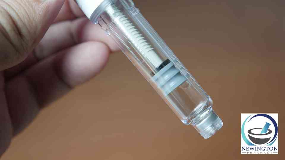 close-up of person holding weight loss injection on brown background