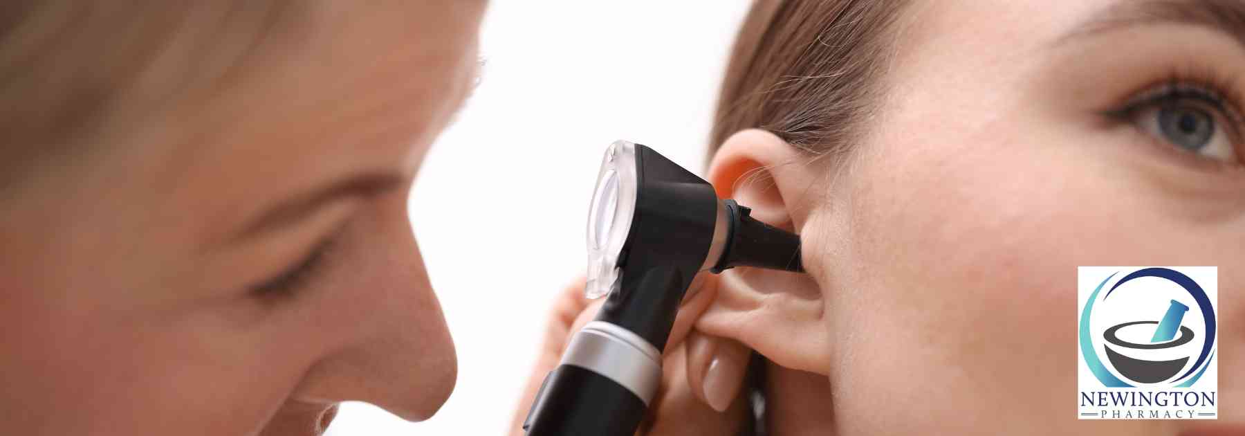 female doctor examining ear of female patient