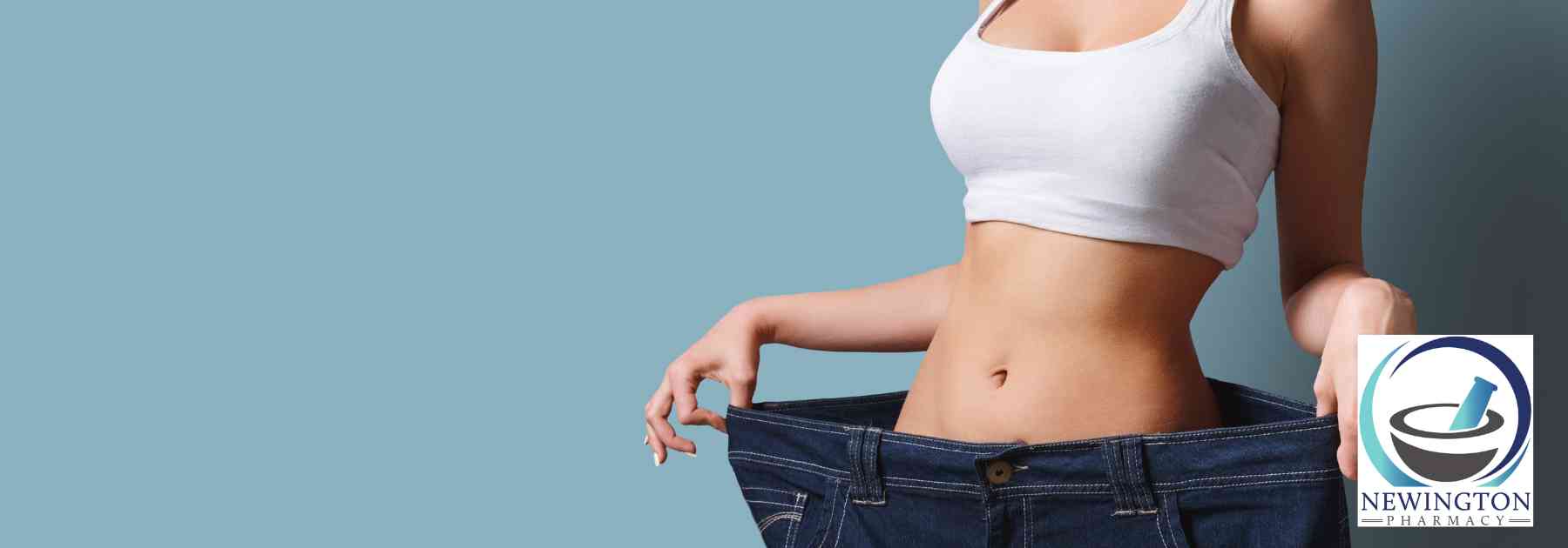 woman in white crop top wearing jeans too big on blue background
