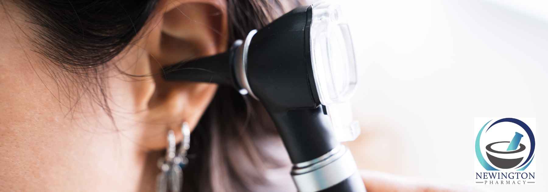 close-up of doctor examining ear of female patient