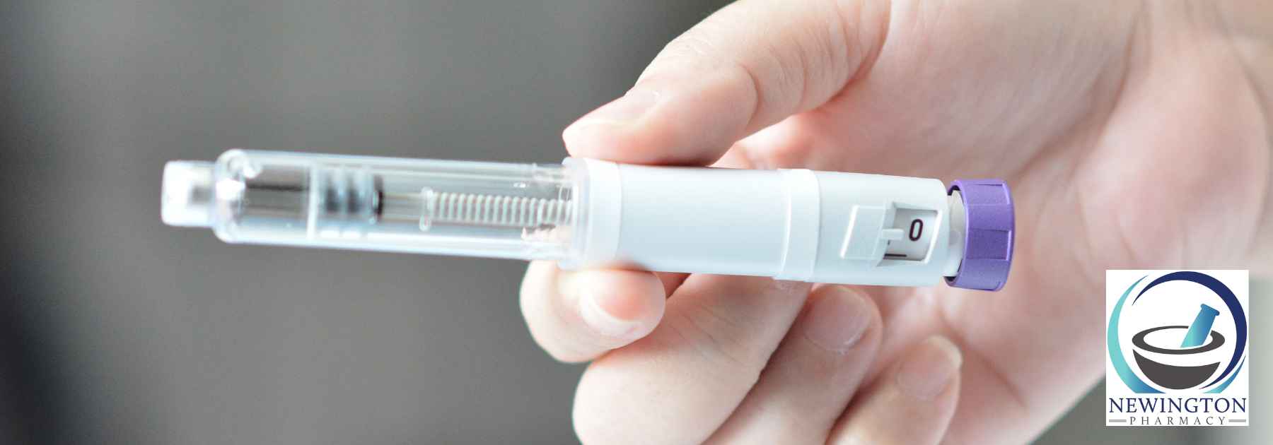 close-up of person holding weight loss injection
