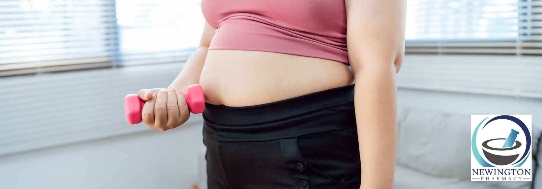 overweight woman in pink crop top lifting weight