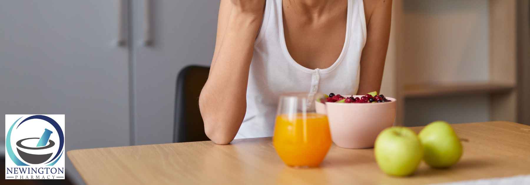 young woman sitting at table eating berries from bowl