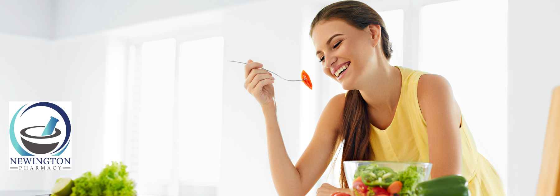 young woman smiling eating salad from bowl